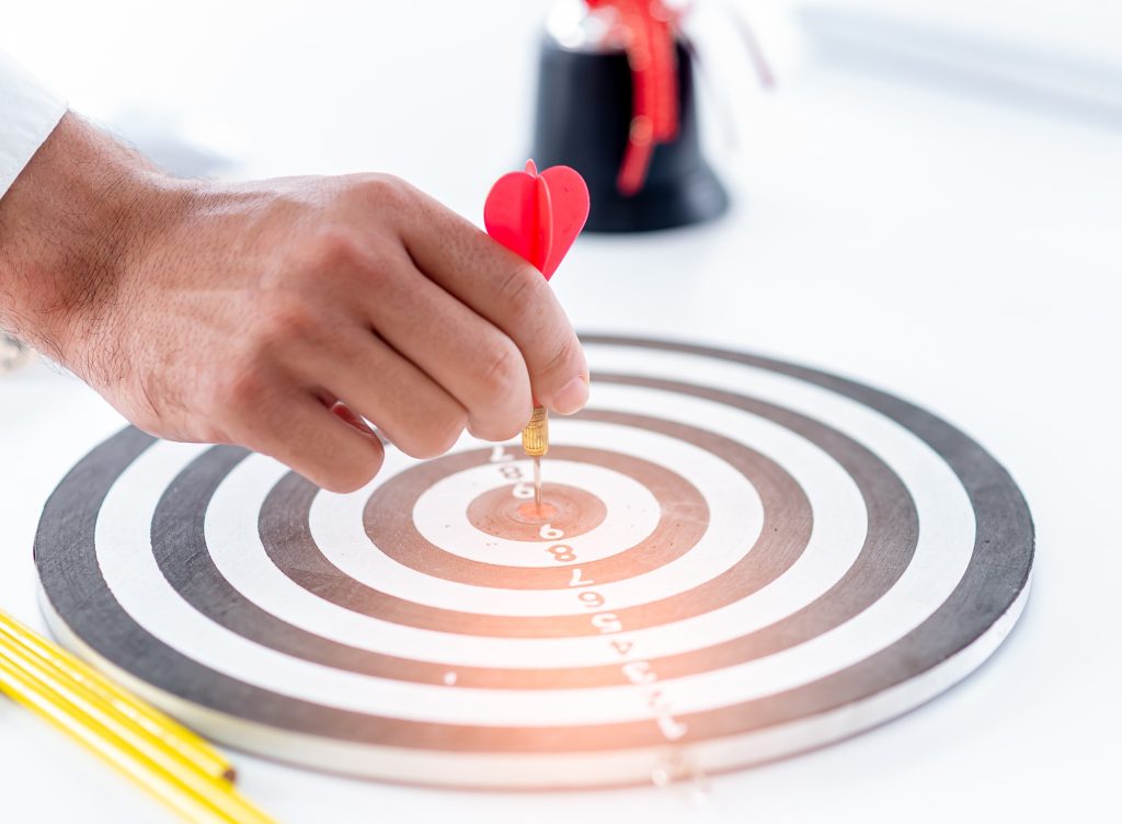 business man push dart to dartboard,concept business targeting and and marketing goal
